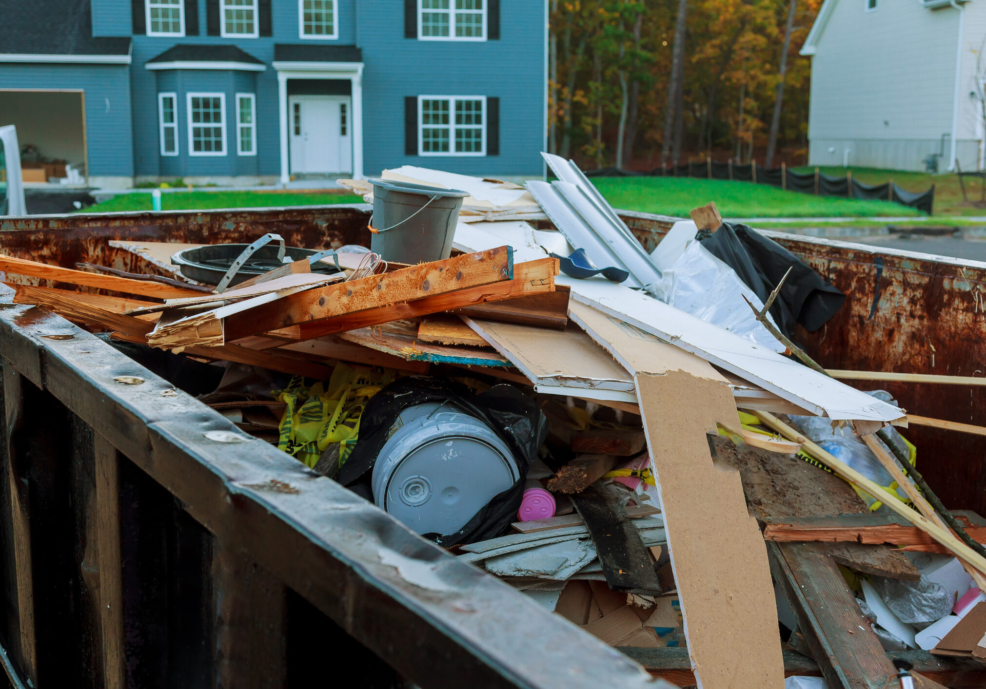 Loaded dumpster near a construction site, home renovation dumpster filled with building rubble dumpster
